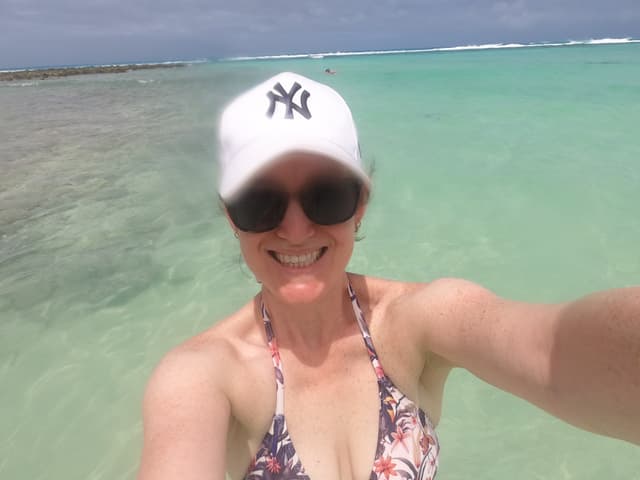 Alicia smiling in turquoise ocean water