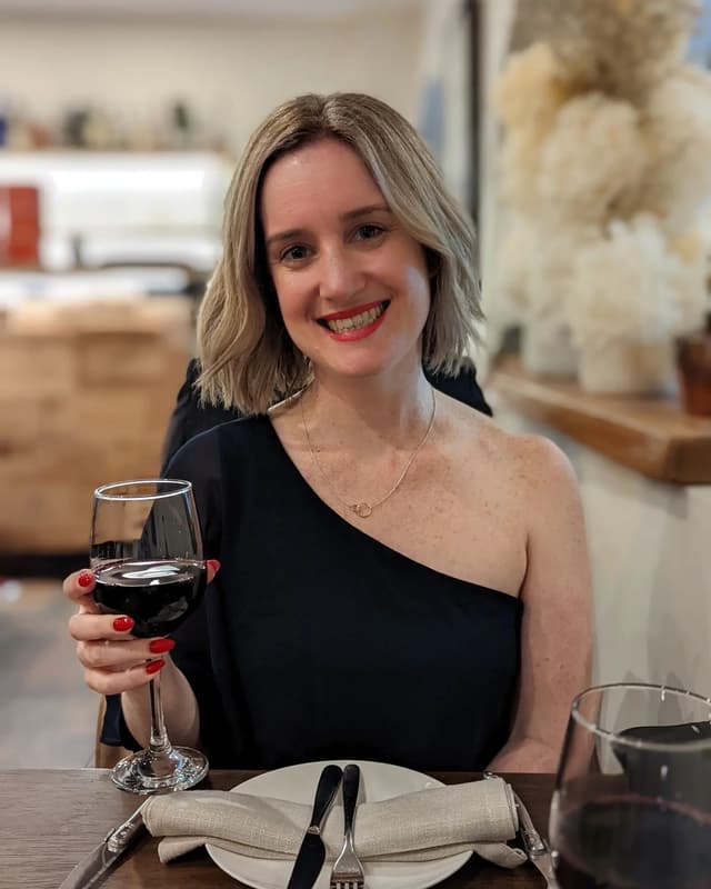 Alicia with a glass of red wine